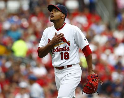 Carlos Martinez reacts after a strikeout following emotional pregame tribute. (Associated Press)