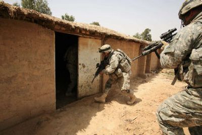 
U.S. soldiers from Alpha Troop, 3rd Squadron, 1st Cavalry Regiment, 3rd Infantry Division, search for a mortar man who fired on an American base Saturday. 
 (Associated Press / The Spokesman-Review)