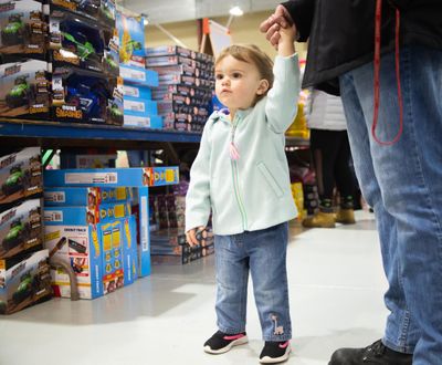 Runa Hubbard, who is almost two years old, soaks in the activity at the 2019 Christmas Bureau last week. The Christmas Bureau is open from 10 a.m. to 2:30 p.m. daily through Dec. 20, and does not require proof of income, though adults need to bring proof of address and identity, and kids 17 and younger must have correlating documents. (Libby Kamrowski / The Spokesman-Review)