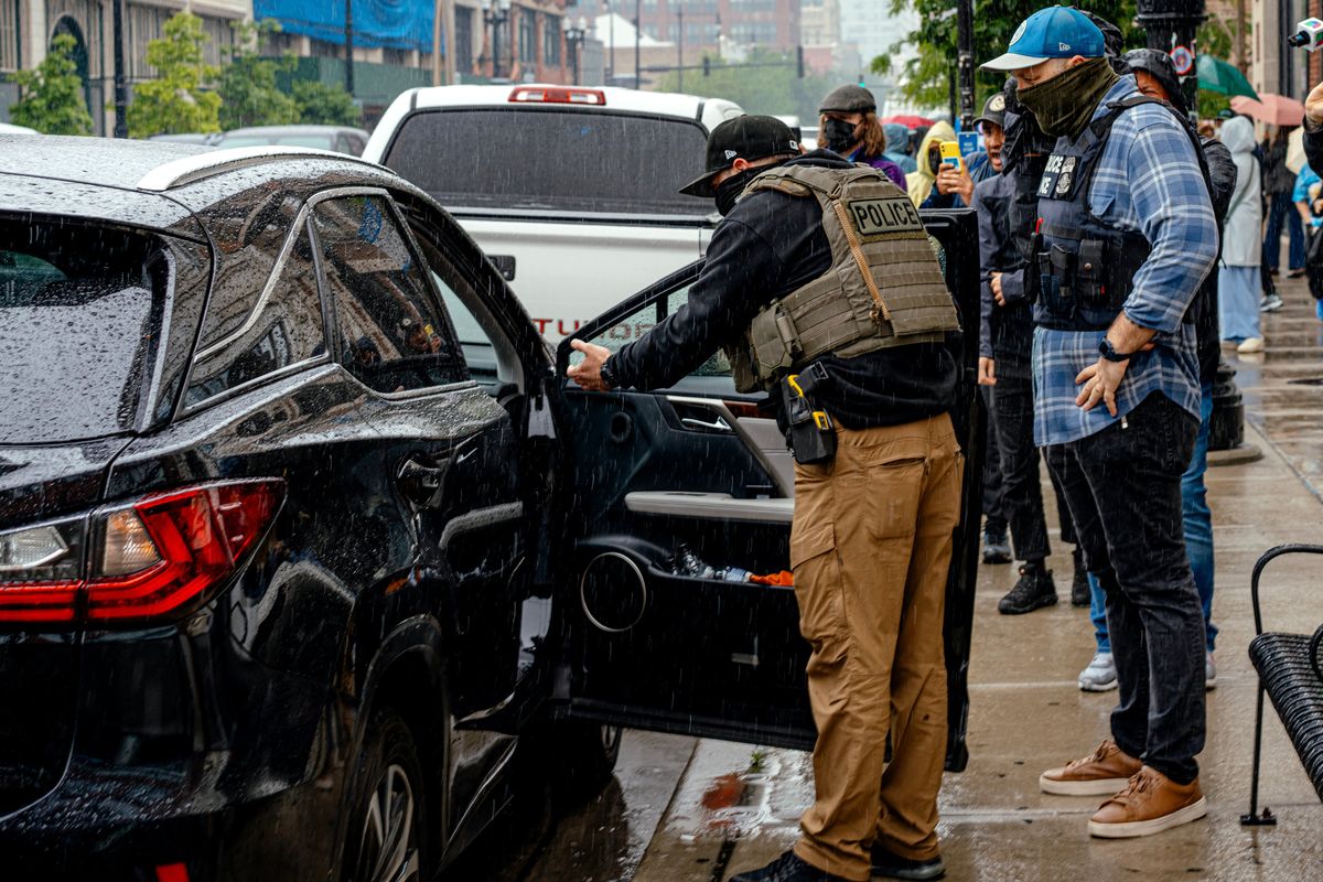 Immigration agents prepare to detain an immigrant from Pakistan in a friend’s car on June 4 in Chicago. With the passage of Trump’s domestic policy law, the Department of Homeland Security is poised to hire thousands of new Immigration and Customs Enforcement (ICE) agents and double detention space. (JAMIE KELTER DAVIS)