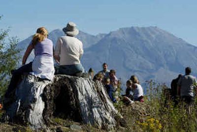
With Mount St. Helens at a Level 3 alert, onlookers near the volcano watch for signs of seismic activity on Sunday at the Castle Lake viewpoint in Washington. 
 (Associated Press / The Spokesman-Review)