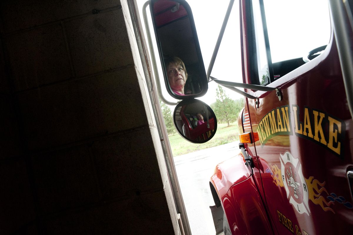 Toni Halloran, Deputy Chief of Newman Lake Fire and Rescue, concentrates as she maneuvers a water tender into the cramped confines of Station 1 in October  2013, in Spokane. The Newman Lake Fire Auxiliary is preparing to hold a hot dog and T-shirt fundraiser on Saturday, July 1, 2017, to benefit the Newman Lake Fire and Rescue. (Tyler Tjomsland / The Spokesman-Review)