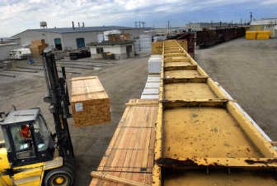 
Mike Young, a warehouseman at Inland Empire Distribution, loads a train car Thursday. A proposal to build  a similar site on the Playfair site is supported by Councilman Al French.   
 (Jed Conklin / The Spokesman-Review)