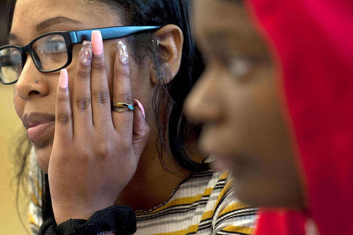 Roger High School seniors Mika Brewer and Shareeda Whitehurst listen to teacher Jaime Stacy during a meeting of the Strong Women Achieving Greatness club, or SWAG, on Tuesday, May 28, 2019. (Kathy Plonka / The Spokesman-Review)