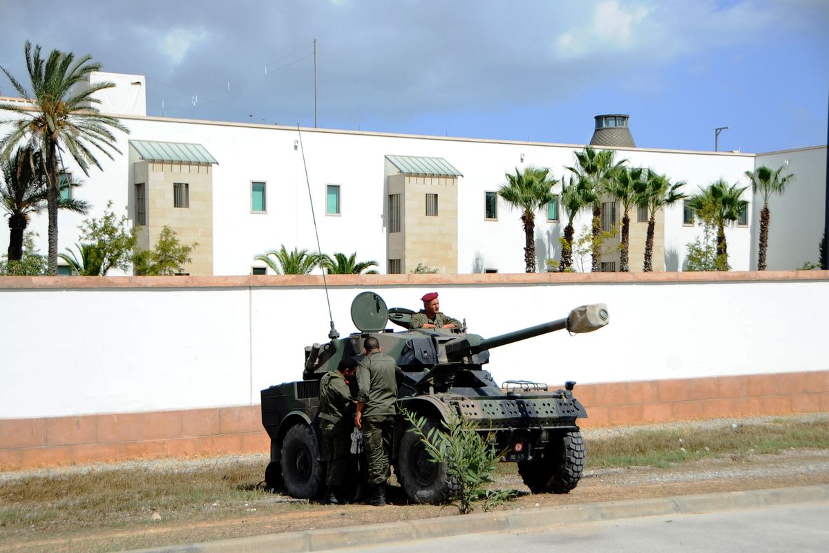 Tunisian police and army vehicles surround  the U.S. Embassy, a day after several thousand demonstrators angry over a film that insults the Prophet Muhammad stormed the compound, Tunis, Tunisia, Saturday, Sept. 15, 2012. Tunisia