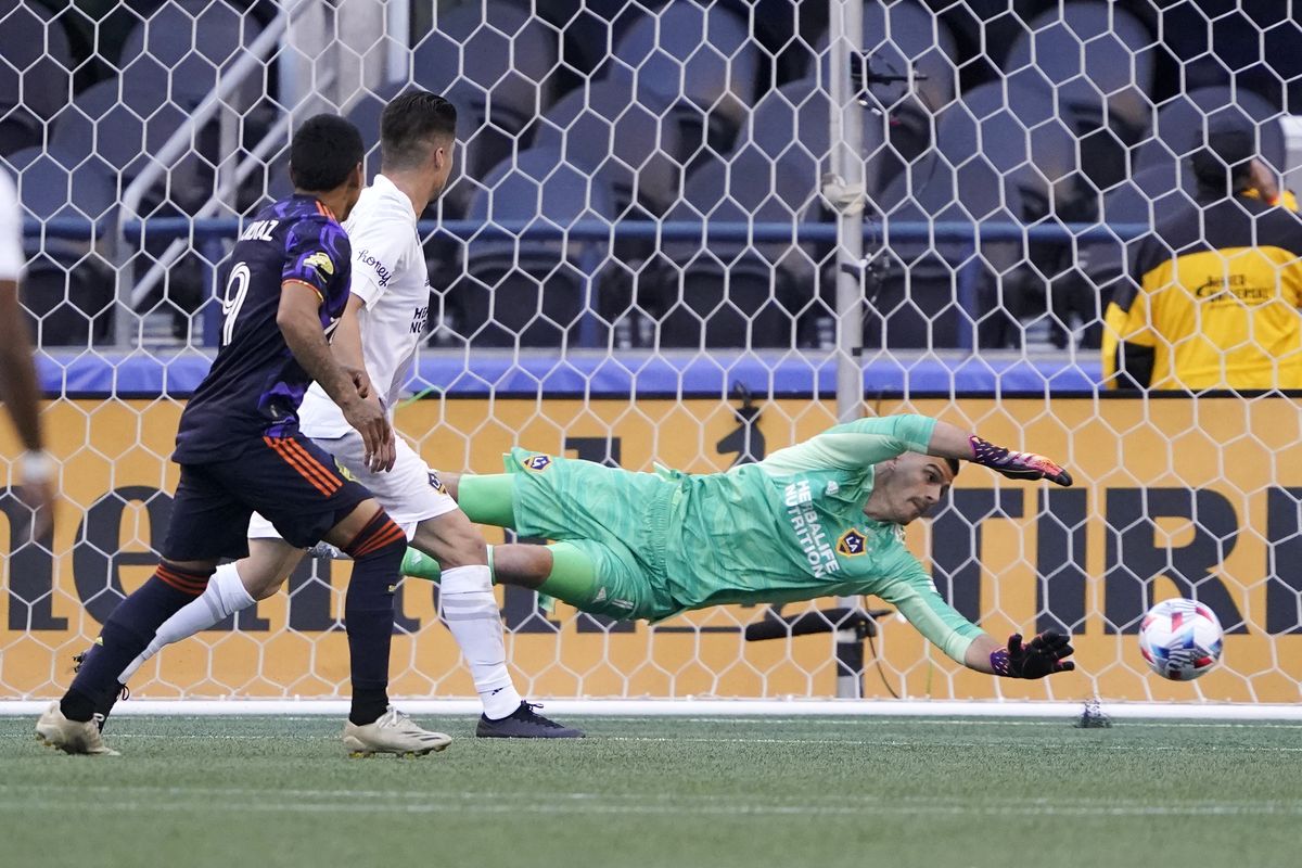 Los Angeles Galaxy goalkeeper Jonathan Bond dives but can