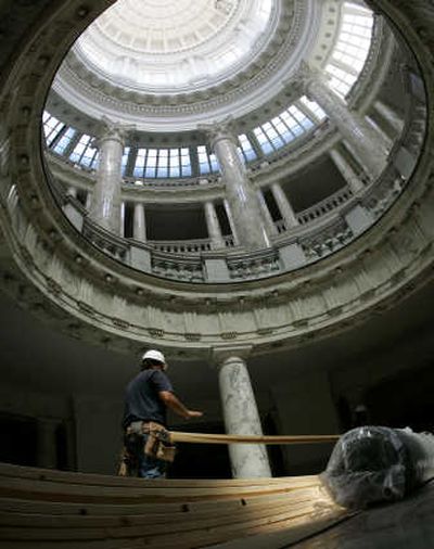 
Workers carry boards used to protect marble floors from construction debris during Capitol renovation in July. Work at the Boise Statehouse is being scaled back because of budget issues. Associated Press
 (File Associated Press / The Spokesman-Review)