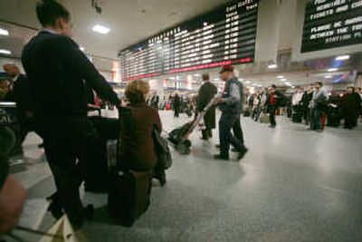 
Travelers wait for Amtrak and commuter trains at Penn Station in New York on Jan. 10. A  labor dispute between Amtrak and nine unions has come to a preliminary resolution, avoiding a strike. Associated Press
 (Associated Press / The Spokesman-Review)