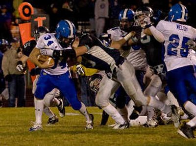 
Coeur d'Alene's Justin Goodwin, left, is taken down by Lake City middle linebacker Byron Hout for a loss.
 (Bruce Twitchell / The Spokesman-Review)