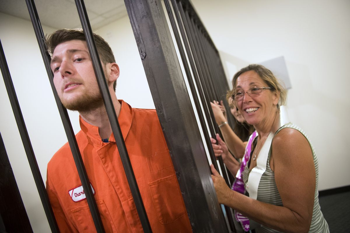 Lauren Williams, right, tries to pry a clue from an inmate played by Escape employee Adam Scott. (Colin Mulvany)