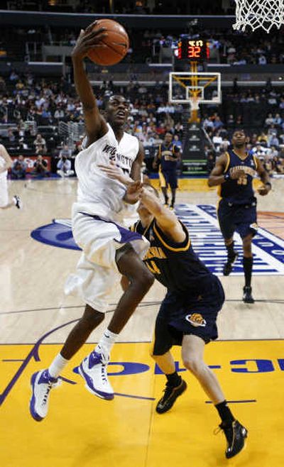 
UW's Justin Holiday is fouled on a drive by Cal's Eric Vierneisel. Associated Press
 (Associated Press / The Spokesman-Review)