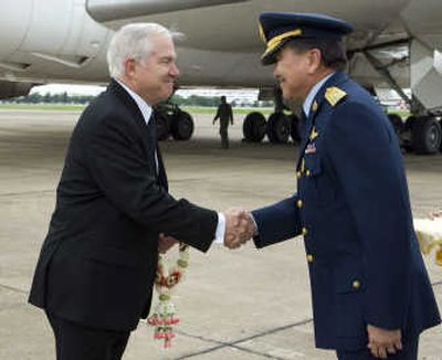 
Robert Gates is greeted upon his arrival to Bangkok on Sunday by Air Chief Marshal Chalit Pookpasuk. Associated Press
 (Associated Press / The Spokesman-Review)