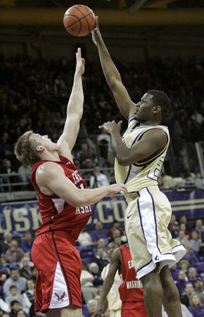 
Washington's Jamaal Williams, right, shoots over Eastern's Henry Bekkering on Friday night.
 (Associated Press / The Spokesman-Review)