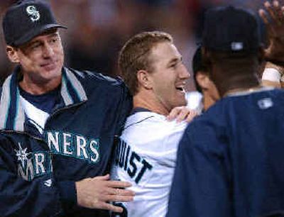 
Willie Bloomquist scored the winning run and got a pat on the back from Bob Melvin. 
 (Associated Press / The Spokesman-Review)