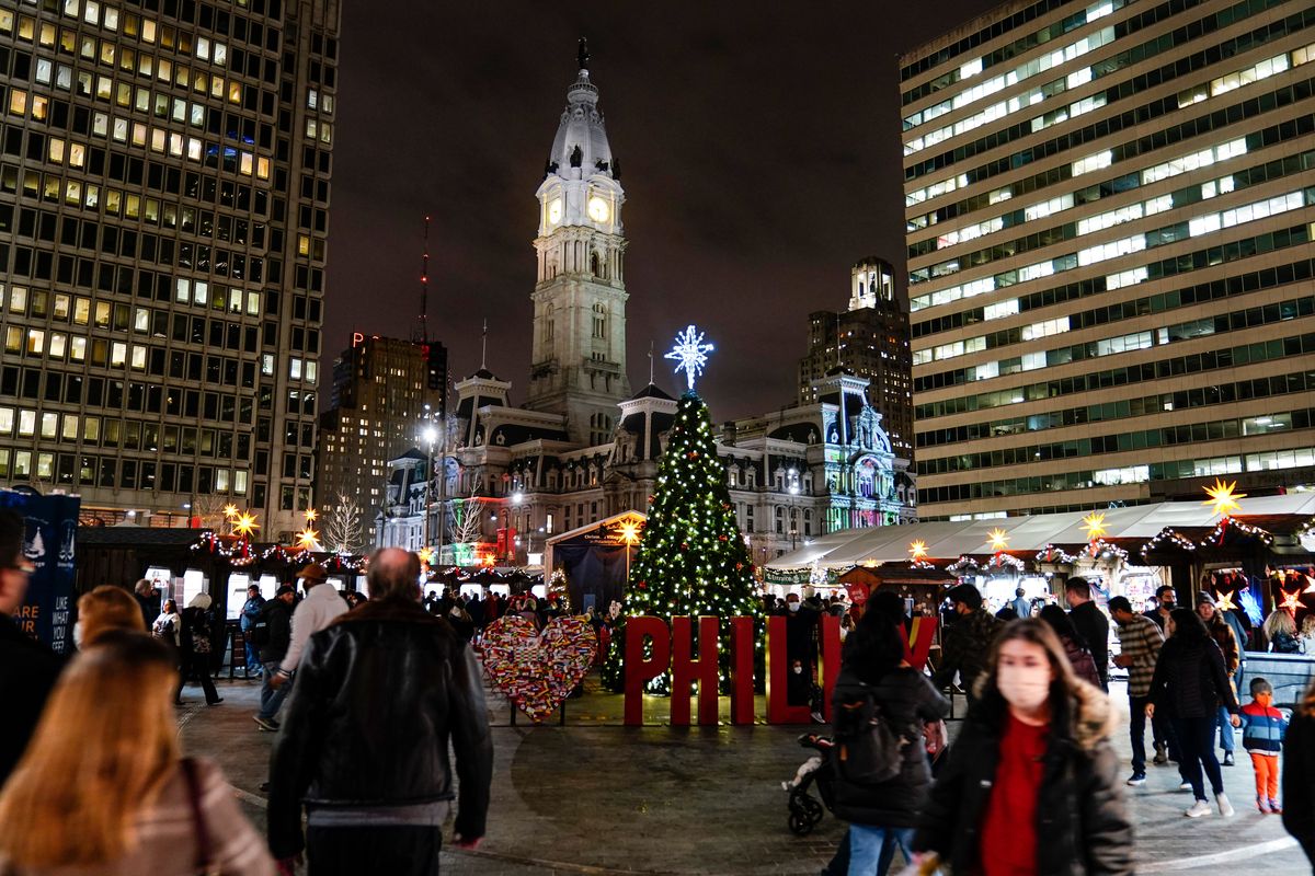 People, including some wearing face masks to protect against the spread of the coronavirus, visit the Christmas Village in Philadelphia, on Wednesday.  (Matt Rourke)