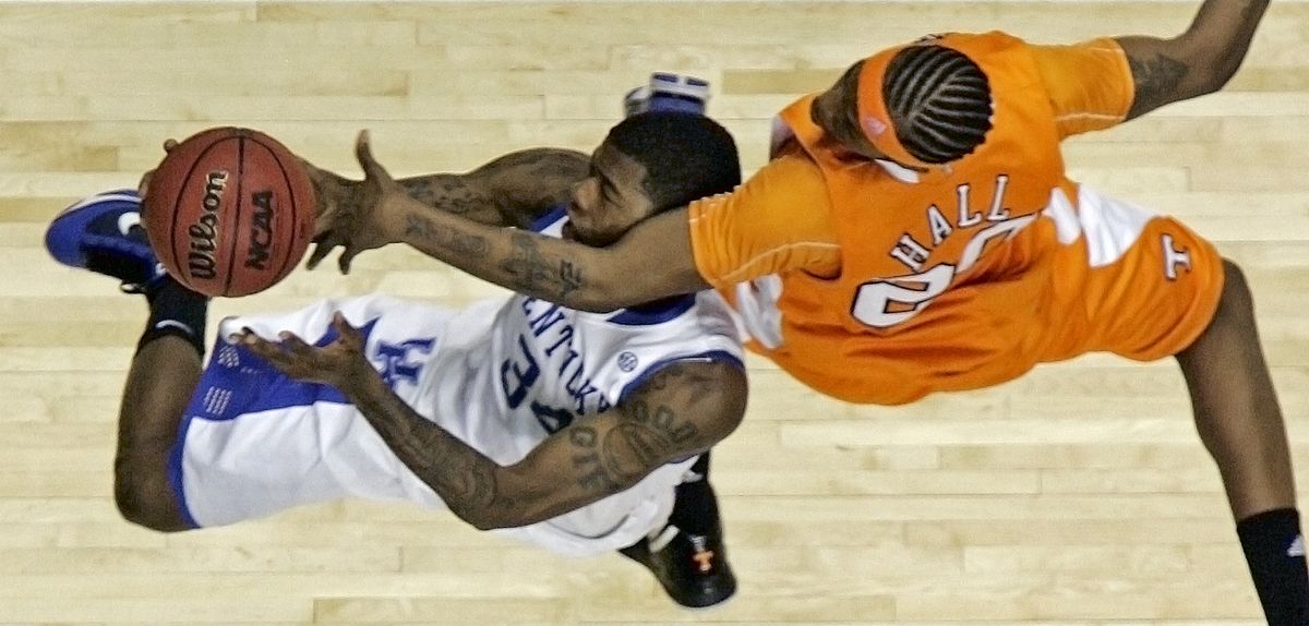 Kentucky’s Deandre Liggins (34) is fouled by Tennessee’s Kenny Hall (20) during their SEC semifinal game in Nashville, Tenn. (Associated Press)