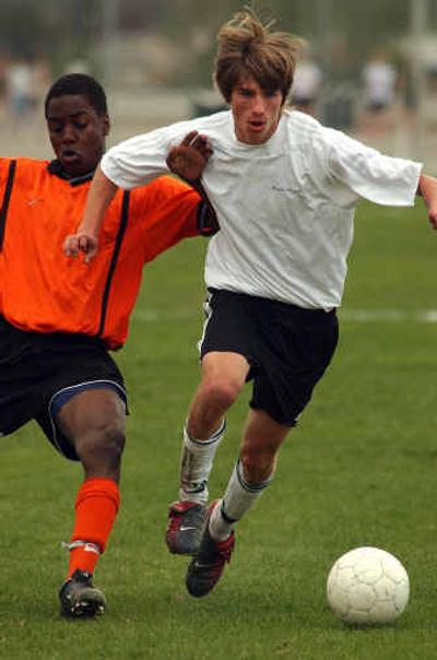 
East Valley High's Ben Funkhouser, right, goes head to head with Lewis and Clark's Forrest Gilles during a game at EV May 2.
 (Liz Kishimoto / The Spokesman-Review)