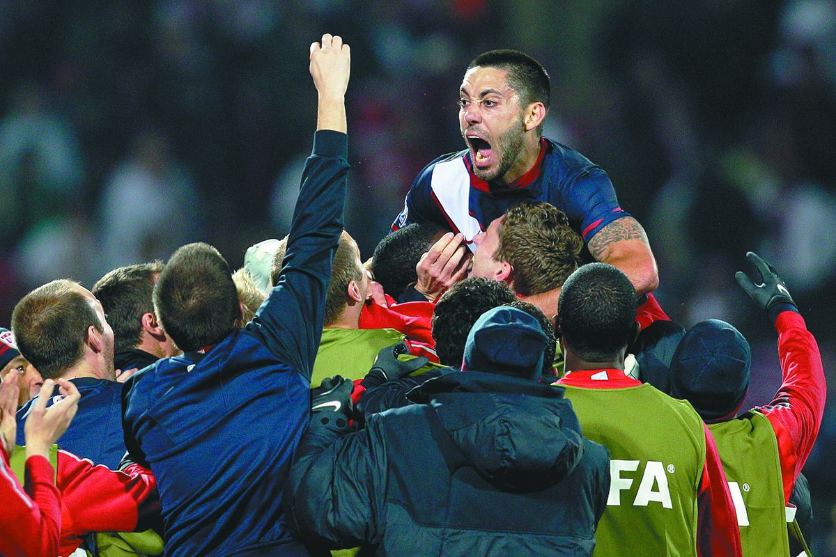 Clint Dempsey, top, gets a lift from his American teammates after scoring in the 40th minute against England.  (Associated Press)