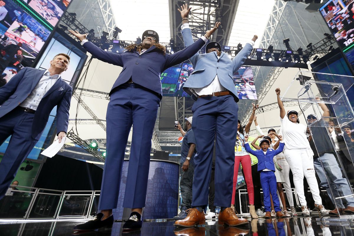 Shaquem Griffin, right, and his twin brother Seattle Seahawks cornerback Shaquill Griffin celebrate on stage during the NFL football draft in Arlington, Texas, Saturday, April 28, 2018. The Seahawks selected Shaquem in the fourth round. (Jae S. Lee / AP)