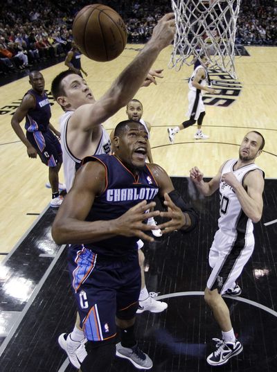 Spurs’ Aron Baynes, left, battles Bismack Biyombo for a rebound. (Associated Press)
