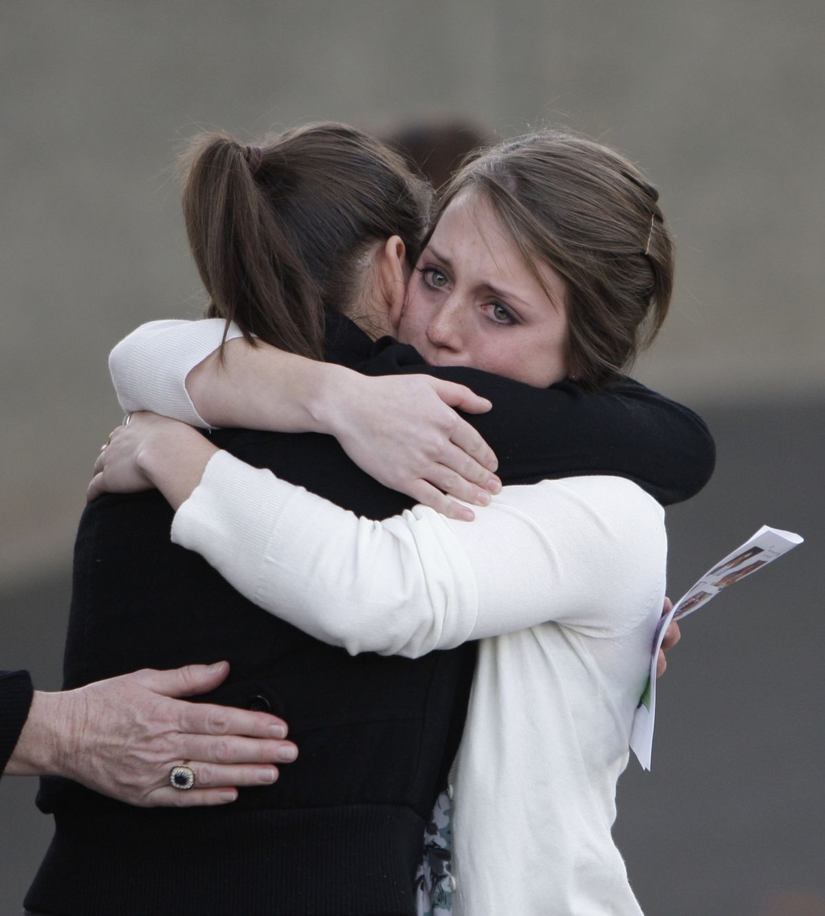 Columbia High School student Kelsey Spadaro, 15, right, hugs classmate Joanna Villa, 17, before a memorial service Monday in White Salmon, Wash. Associated Press photos (Associated Press photos / The Spokesman-Review)