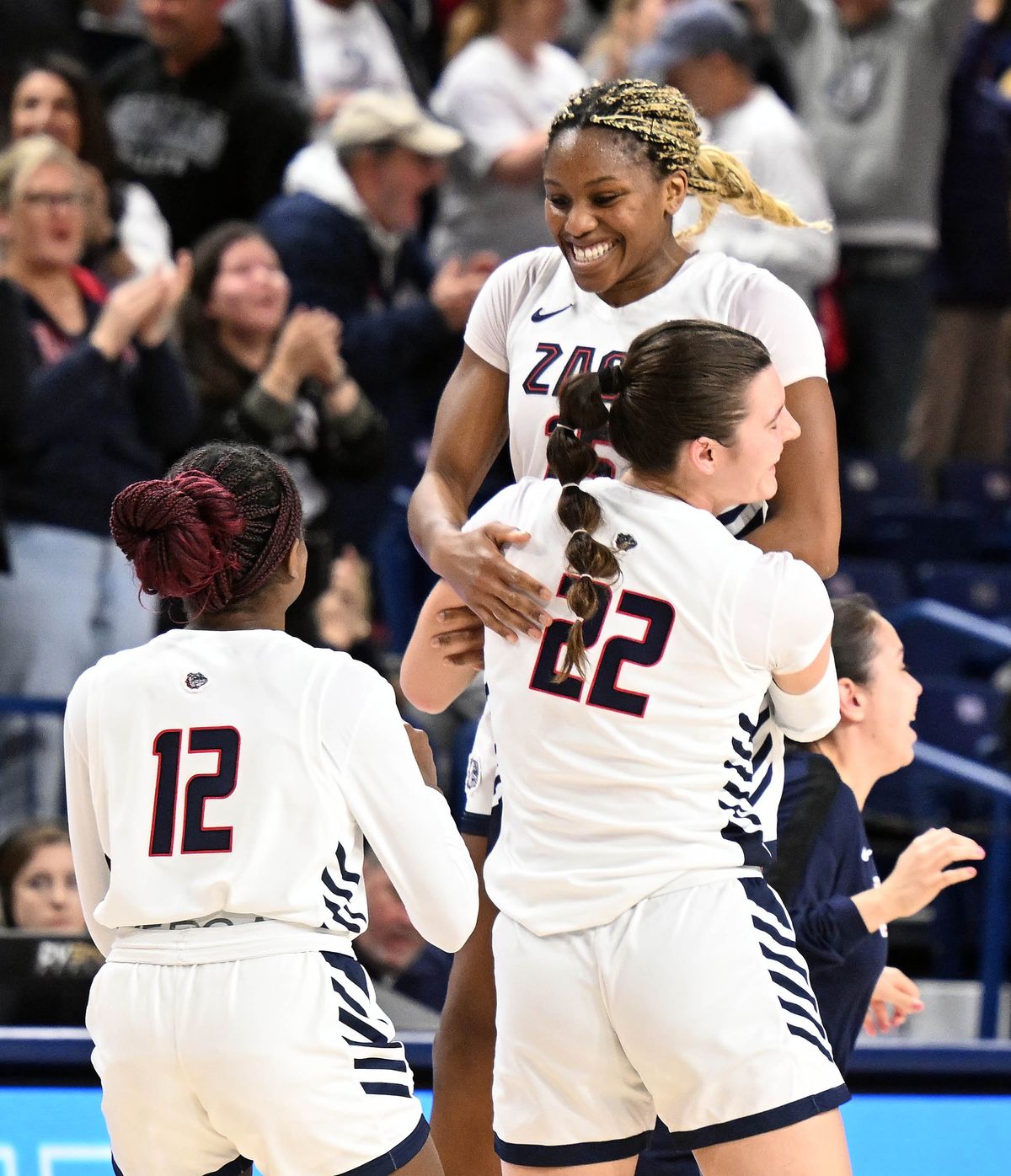 Gonzaga forward Yvonne Ejim (15) celebrates with forward McKynnlie Dalan (22) and guard Christabel Osarobo (12) after the clock ran out on the Portland Pilots. The Zags won 66-65 during an NCAA college basketball game Thursday, Jan. 16, 2025, at the McCarthey Athletic Center. (COLIN MULVANY)