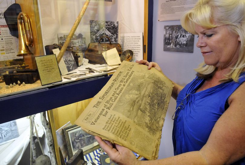 Jayne Singleton, director of the Spokane Valley Heritage Museum, reads a list of Civil War veterans from a 1913 Spokesman-Review Tuesday at the museum. Sources like the old newspaper helped provide links from area pioneers to the Civil War. (Jesse Tinsley)