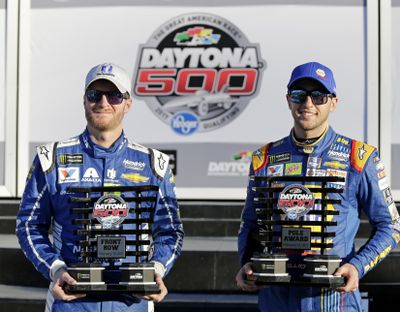 Dale Earnhardt Jr., left, and Chase Elliott display their front-row trophies after qualifying for the top two positions in the NASCAR Daytona 500. (Terry Renna / Associated Press)