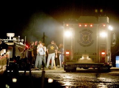 Emergency personnel work at a boat launch in Gibson, La., to coordinate recovery efforts at the helicopter crash site on Sunday.  (Associated Press / The Spokesman-Review)
