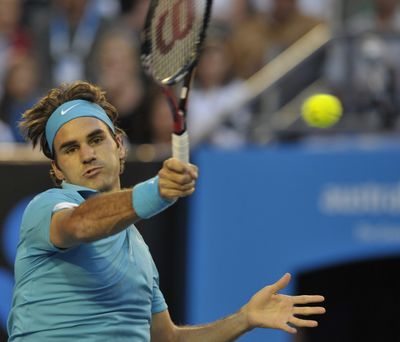Roger Federer of Switzerland returns to Jo-Wilfried Tsonga of France during their semifinal.  (Associated Press)