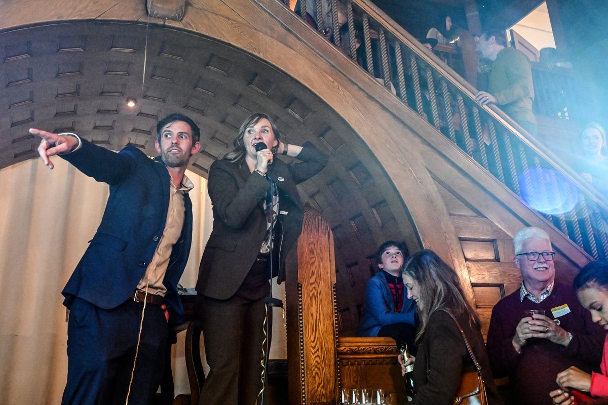 Incumbent City Council member Zack Zappone, left, and candidate Kate Telis watch the first election results with their supporters in the Glover Mansion on Tuesday in Spokane. (Jesse Tinsley/THE SPOKESMAN-REVIEW)