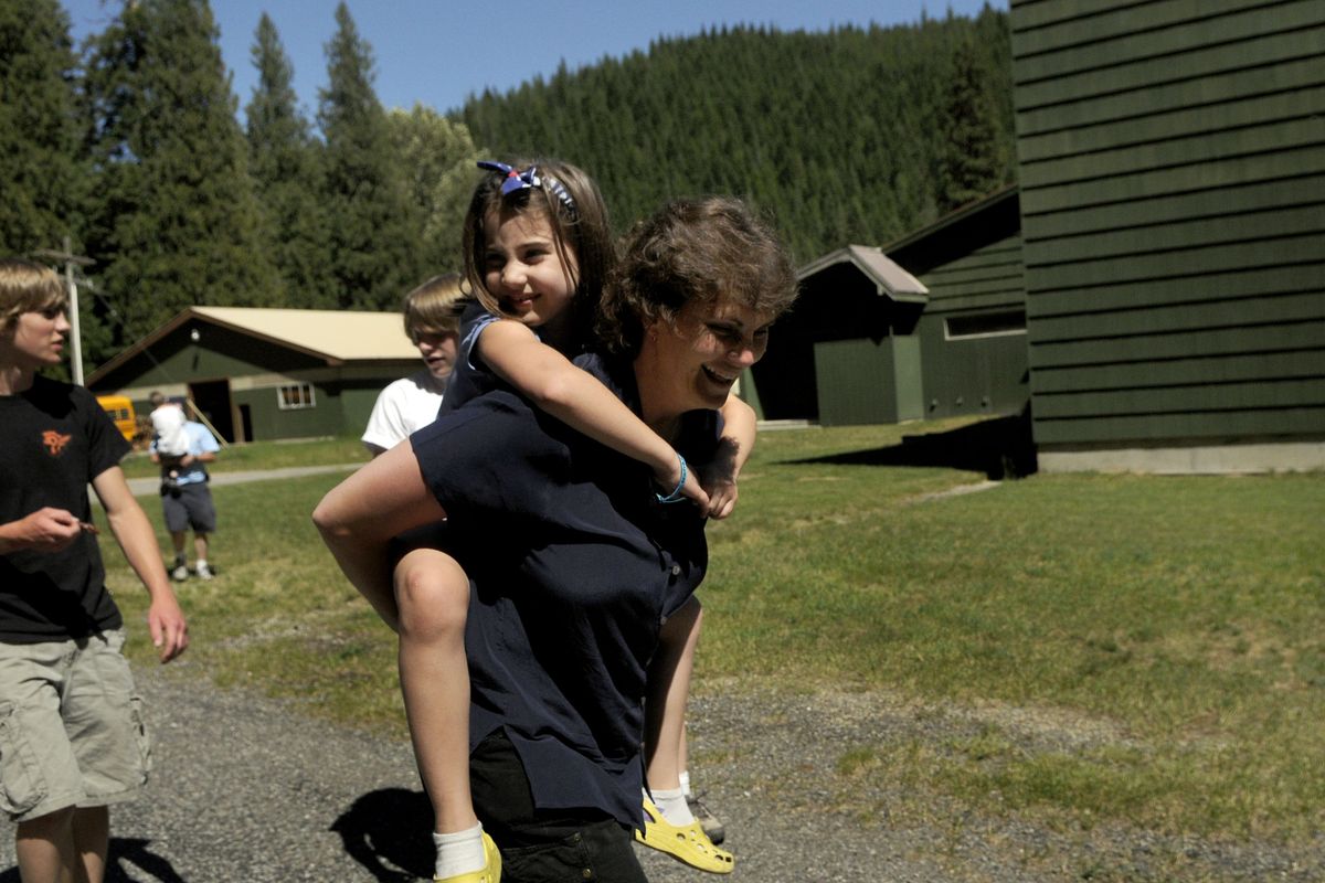 Tammy Loe carries her daughter Olivia, 7, through Lutherhaven’s Shoshone Base Camp. For camp-share partners, Lutherhaven provides its property, buildings, counselors, food, cooks and liability insurance.