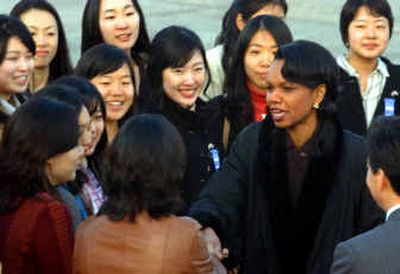 
Secretary of State Condoleezza Rice, right, is greeted by students upon her arrival in Seoul on Saturday. 
 (Associated Press / The Spokesman-Review)