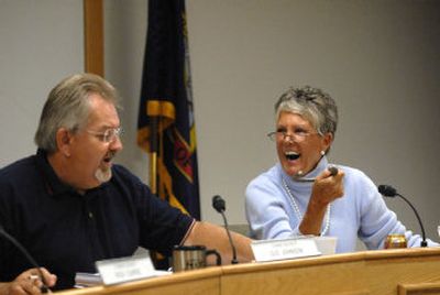 
Kootenai County Commissioner Katie Brodie laughs and holds an old horseshoe that  Commission Chair Gus Johnson, left, gave her  during a hearing about the proposed Powderhorn Bay golf course development in September. 
 (Jesse Tinsley / The Spokesman-Review)