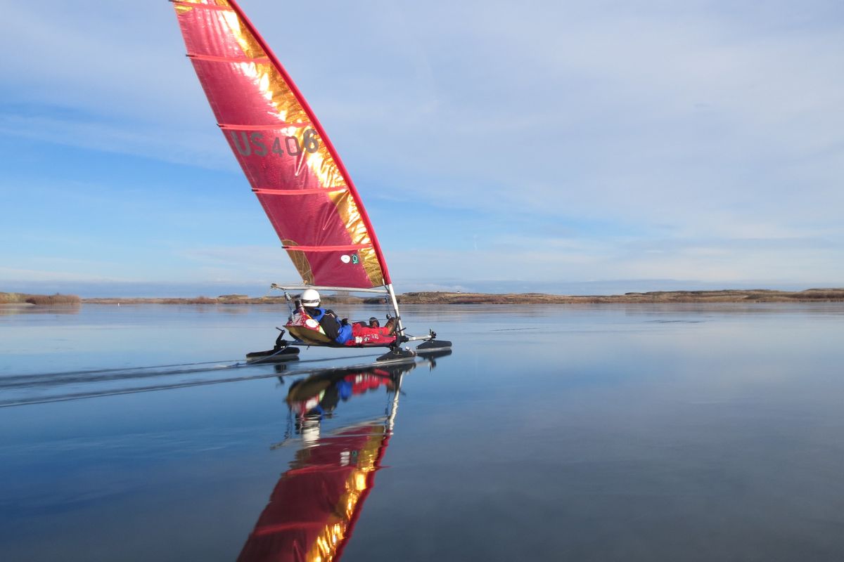 Frank Caccavo, a professor at Whitworth University, sails his iceboat through a film of meltwater on Sprague Lake on January 12, 2014. The boat is an Imac landsailer coverted with blades for sailing over the ice. (Dave Farmer)