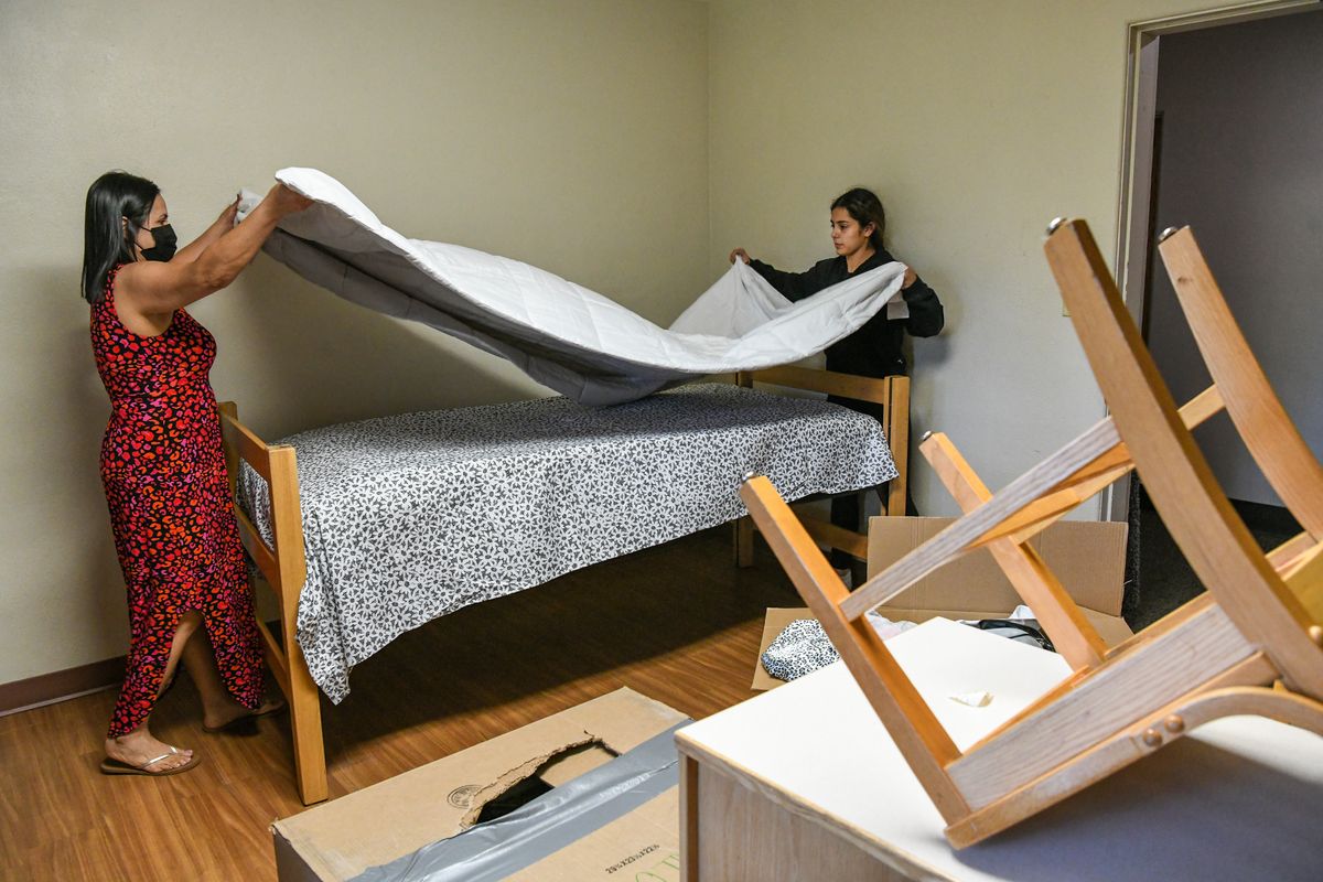 Eastern Washington University freshman Duvy Mendoza, from Tri-Cities, right, and her mother, Griselda Ochoa, get Devy’s dorm room ready Thursday in Anderson Hall, on move-in day Cheney.  (DAN PELLE/THE SPOKESMAN-REVIEW)
