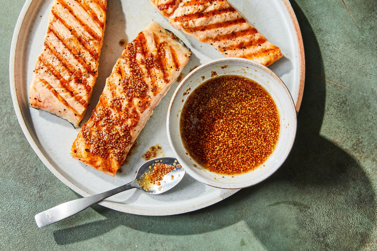 South Carolina mustard BBQ sauce with grilled salmon.  (LINDA XIAO/The New York Times)