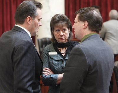Sen. Sheryl Nuxoll, R-Cottonwood, center, talks with Sens. Russell Fulcher, R-Meridian, left, and Cliff Bayer, R-Boise, while the Senate is at ease, following Nuxoll's motion to begin the amendment process on the governor's insurance health exchange bill. (AP/Idaho Statesman / Katherine Jones)