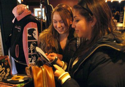 
Jessica Birney, left, 16, from Fairfield, Calif., and her cousin Ashley Garza, 16, from Olive Branch, Miss., look through Elvis items in a store across the street from Graceland in Memphis, Tenn. 
 (Associated Press photos / The Spokesman-Review)