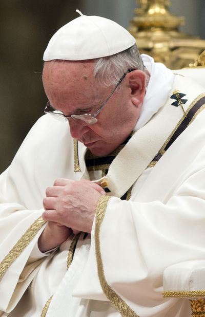 Pope Francis prays as he celebrates an Easter Vigil service Saturday night in St. Peter's Basilica, at the Vatican. (Associated Press)