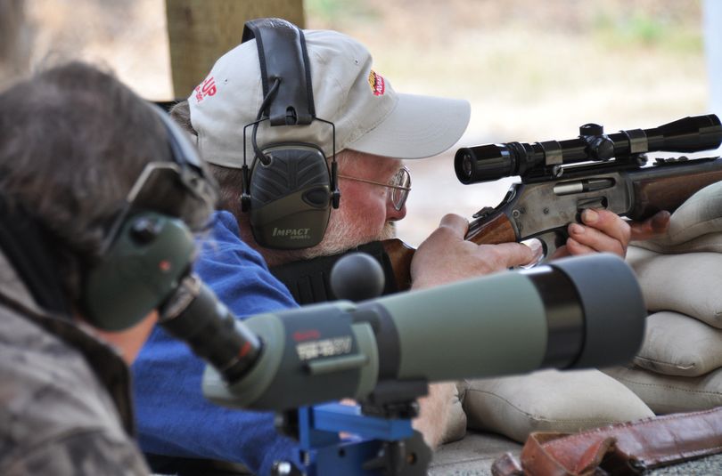 A shooter checks his hunting rifle at the Spokane Rifle Club with help from a club member during the annual fall Sight-in Days. (Rich Landers)