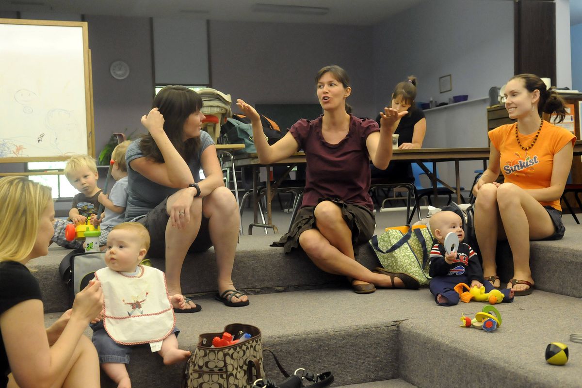 Amy Shook, center, gestures as she talks with other members of the Mindful Mamas, a group of young mothers that comes together to support each other, share ideas and ask questions.  (Jesse Tinsley)