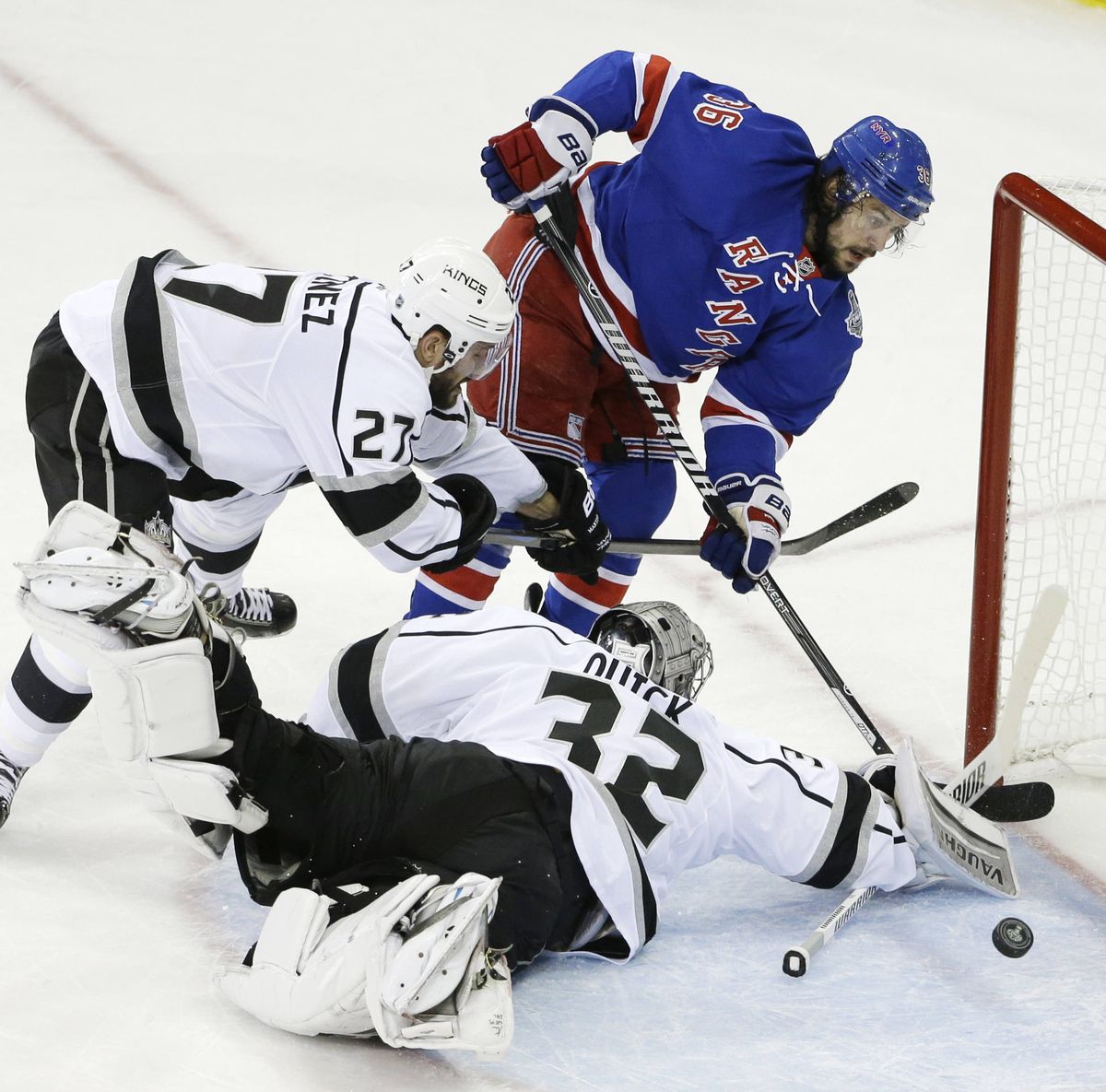 Los Angeles Kings goaltender Jonathan Quick lunges for a first-period save against the New York Rangers’ Mats Zuccarello. (Associated Press)