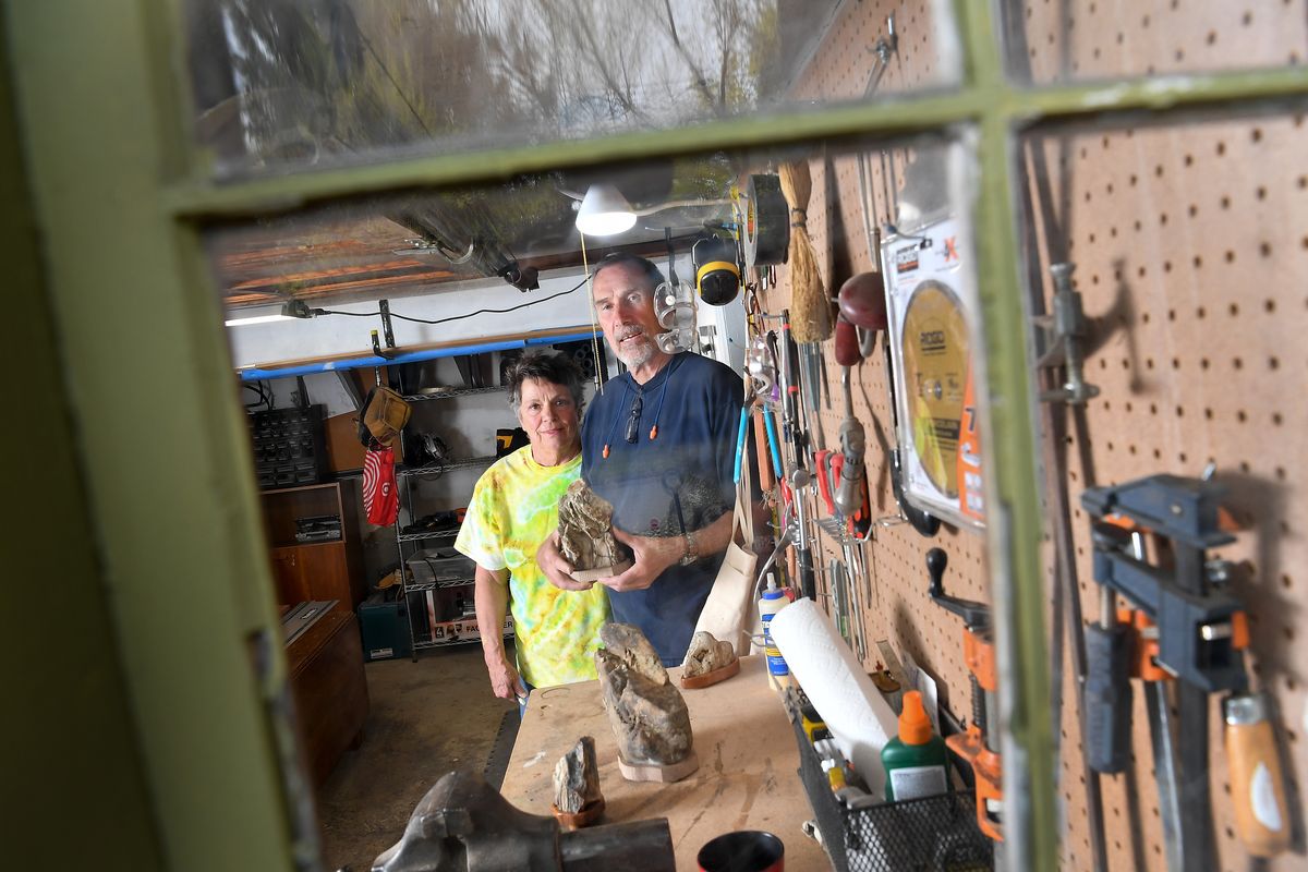 Cass and Rick Johnson are photographed April 29, 2021, with some suiseki stones and wooden platforms, called diaza, that they made in a woodshop at their South Hill home. The couple converted an old garage into a woodshop during the pandemic. (Tyler Tjomsland/The Spokesman-Review)