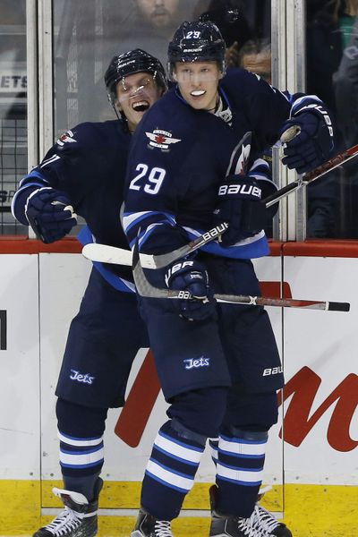 Jets' Nikolaj Ehlers, left, and Patrik Laine celebrate Laine's OT goal. (JOHN WOODS / Associated Press)