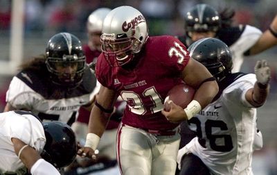 WSU running back Dwight Tardy tries to elude Portland State defenders as he makes his way to the 4-yard line in the second quarter Saturday. (Associated Press / The Spokesman-Review)