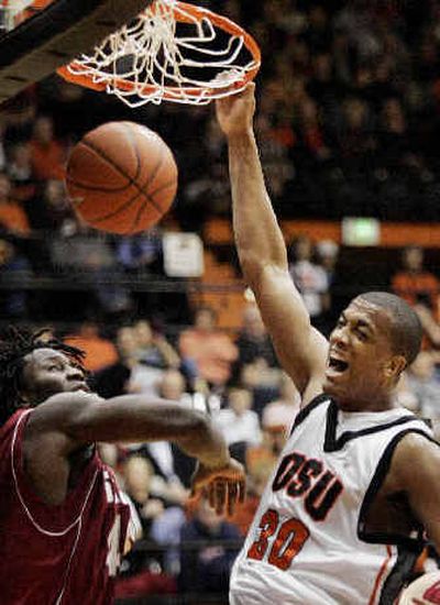 
David Lucas, who led the Beavers with 17 points, dunks in front of Washington State's Jeff Varem in the second half. 
 (Associated Press / The Spokesman-Review)