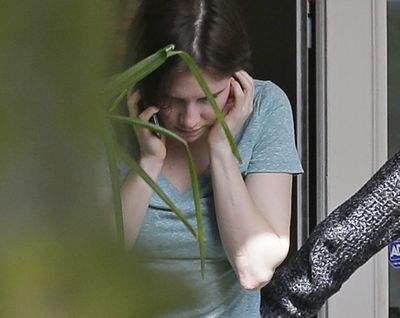 Amanda Knox talks on a phone in the backyard of her mother’s house Friday in Seattle. Italy’s highest court overturned her murder conviction Friday. (Associated Press)