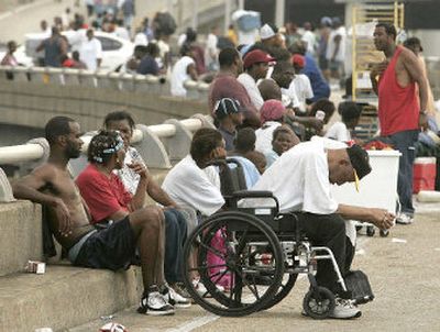 
Thousands of people sit on the freeway on Wednesday after fleeing to higher ground in New Orleans. Water is approximately 12 feet deep in some areas. 
 (Getty Images / The Spokesman-Review)