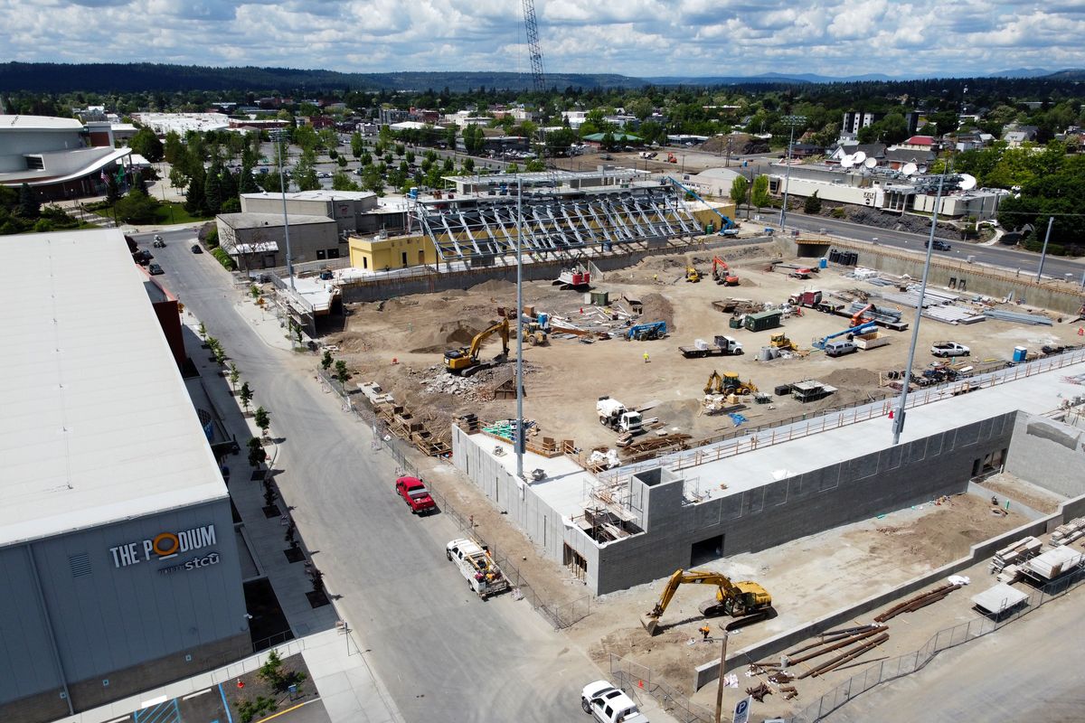 As the new downtown sports arena, right, takes shape across the street from the Podium sports complex, left, the street between the two, Dean Avenue, may be renamed to honor a legendary sports fan, Joe Albi. Photographed Tuesday.   (Jesse Tinsley/THE SPOKESMAN-REVIEW)